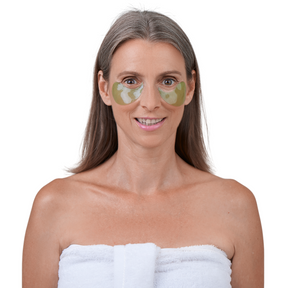 Frau mit aufgelegten Grünalgen Augenpads gegen ihre Augenringe